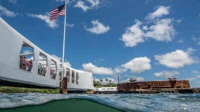 In 1961, Elvis Presley raised $65,000 toward the USS Arizona Memorial; a year later, the 184-foot structure opened above the Pearl Harbor wreck, where more than 900 crewmen remain entombed and oil still leaks