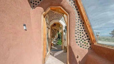 In 2011, a Wyoming couple built a 1,500-sq-ft off-grid home from 1,343 tyres on 55 acres, adding a 66-foot greenhouse, solar panels and rainwater systems; 15 years later, the unusual Earthship is listed for $625,000